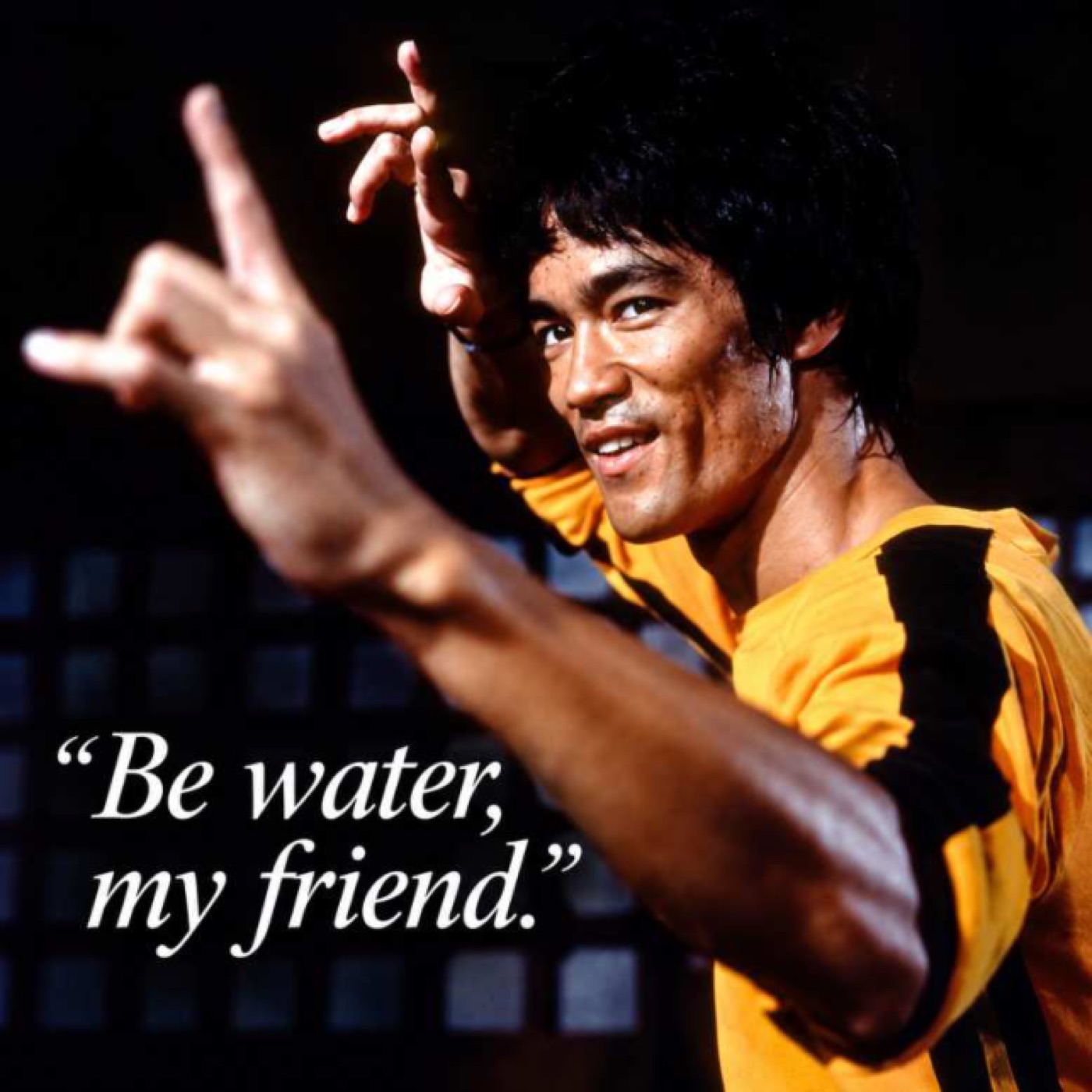 A martial artist in a yellow and black jumpsuit strikes a pose beside the quote Be water, my friend.